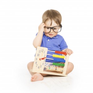Boy child with abacus clock in glasses counting, smart kid