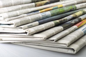 Pile of Various newspapers over white background.